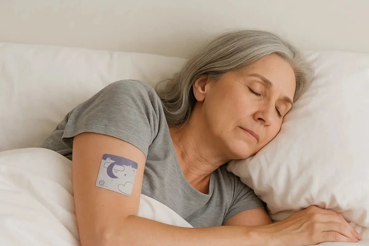 Older woman sleeping peacefully in bed while wearing a sleep patch on her arm.