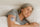 Older woman sleeping peacefully in bed while wearing a sleep patch on her arm.