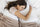 Adult woman sleeping peacefully in bed, representing healthy and restful sleep