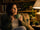 Woman holding green tea cup in evening considering whether green tea before bed helps sleep