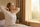 Woman over 50 waking up early in the morning feeling refreshed as a morning person