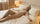 Woman practicing progressive muscle relaxation in bed with peaceful expression and relaxed posture
