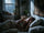 Woman lying awake in bed at night with anxious thoughts, looking toward the ceiling in a dimly lit bedroom.