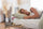 Woman sleeping peacefully on her side during a daytime nap in a cosy bedroom, illustrating the benefits and downsides of napping for sleep quality.